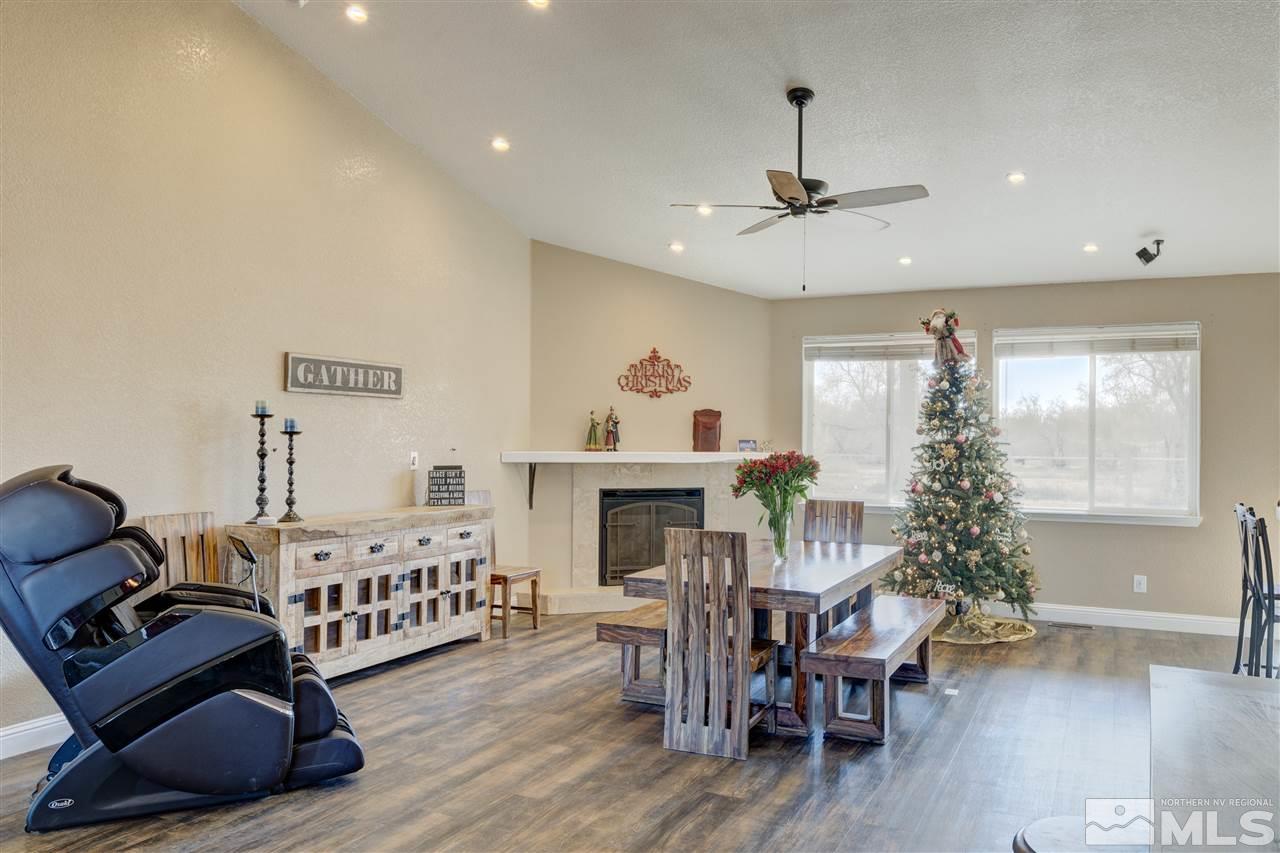 4925 Rancheria Road Fallon, NV 89406 - Photo 10 of 39 a living room with furniture a fireplace and a chandelier