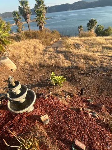 a kitchen with a refrigerator and wooden floor
