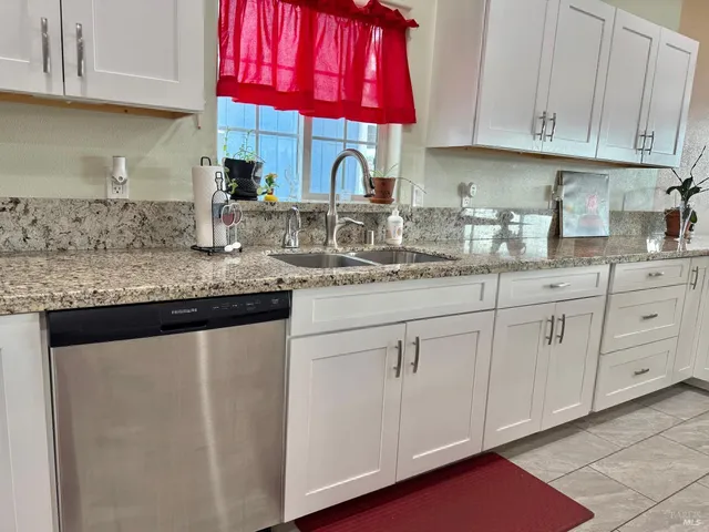 a kitchen with stainless steel appliances granite countertop a stove and a microwave
