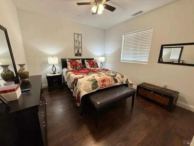 a bedroom with a bed and a night stand
