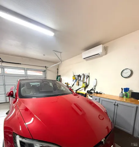 a view of a workspace with furniture and a flat screen tv