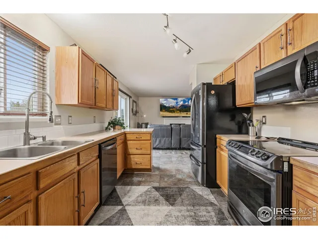 a kitchen with stainless steel appliances granite countertop a sink a microwave and cabinets