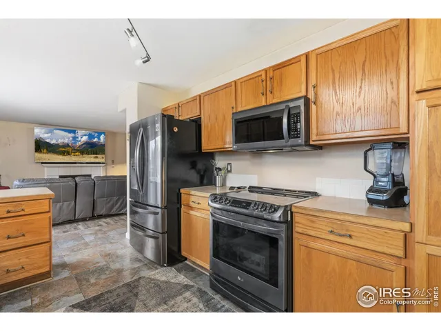 a bedroom with a bed a dresser and a chandelier