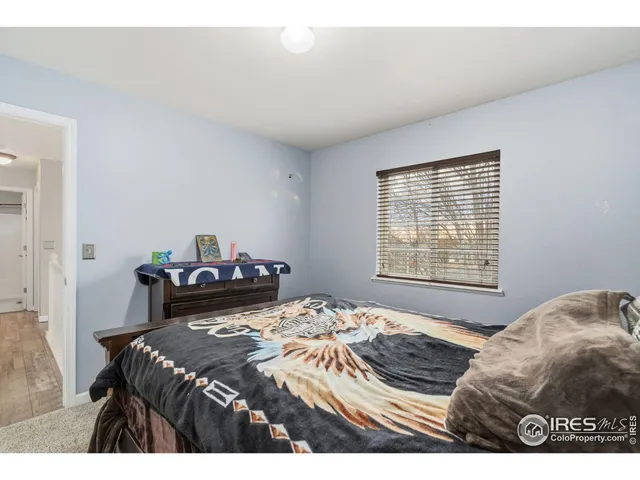 a spacious bedroom with a bed and a cabinets