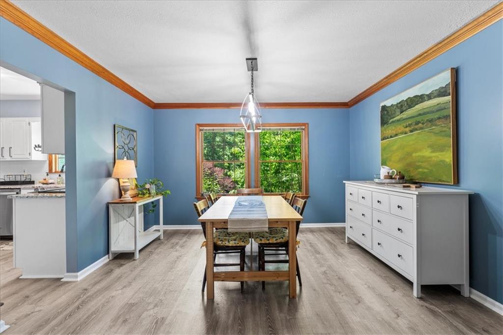 126 Firethorn Road Baden, PA 15005 - Photo 14 of 46 a dining room with a wooden table and chairs