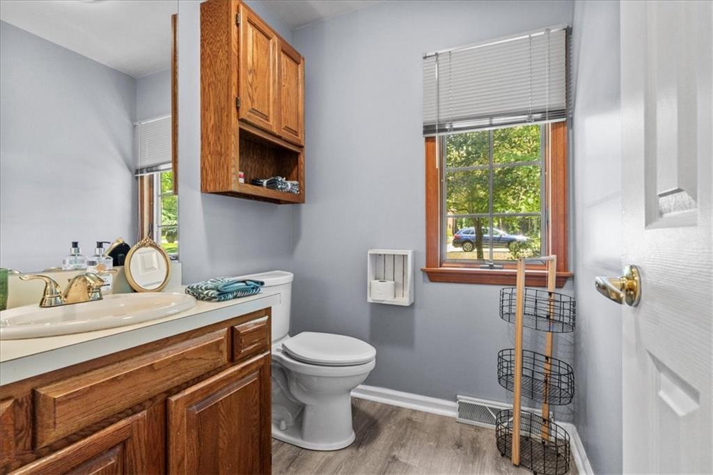 126 Firethorn Road Baden, PA 15005 - Photo 22 of 46 a bathroom with a granite countertop toilet sink and mirror