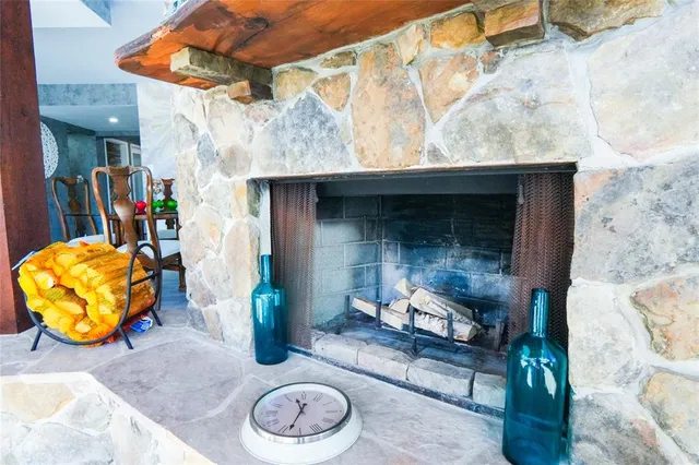 a kitchen with stainless steel appliances granite countertop a stove a sink dishwasher a refrigerator white cabinets and wooden floor