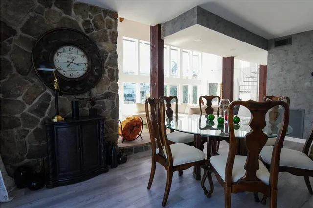 a kitchen with stainless steel appliances granite countertop a sink a window and white cabinets