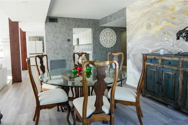 a kitchen with stainless steel appliances a stove a sink and cabinets