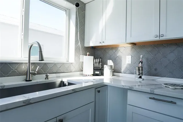 a view of a kitchen with a sink and wooden floor