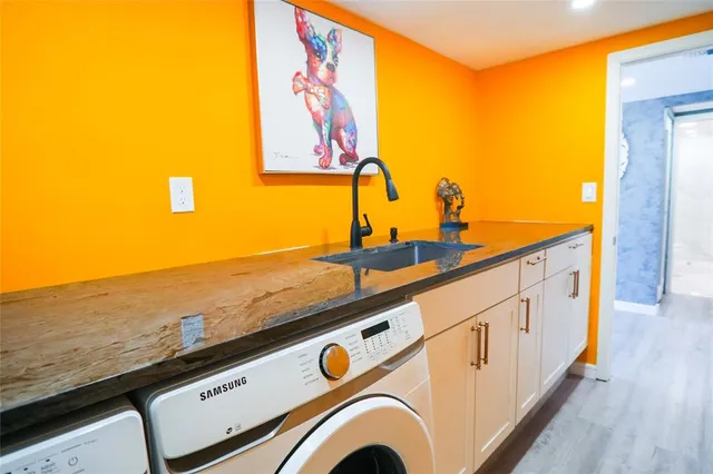 a bathroom with a granite countertop toilet sink and mirror