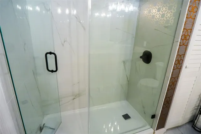 a bedroom with a bed and a flat tv screen on wall