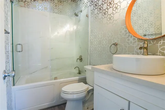 a bedroom with a bed window and wooden floor