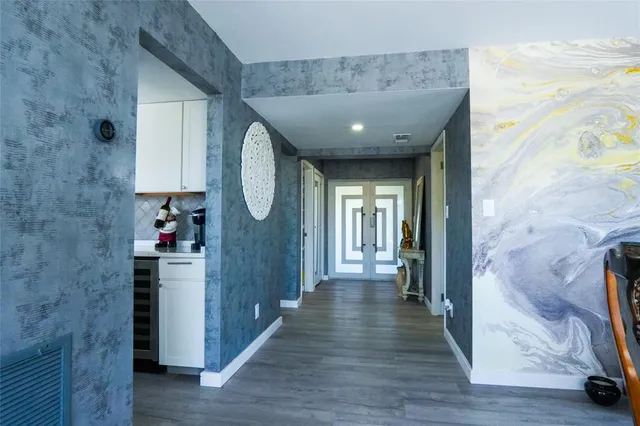 a view of a living room with furniture and a floor to ceiling window