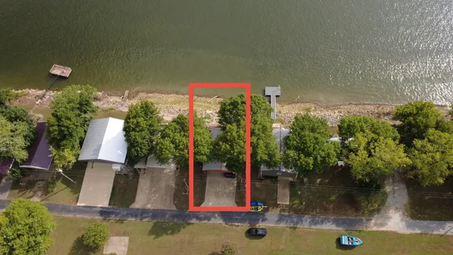 a view of a house with a small pool and a yard