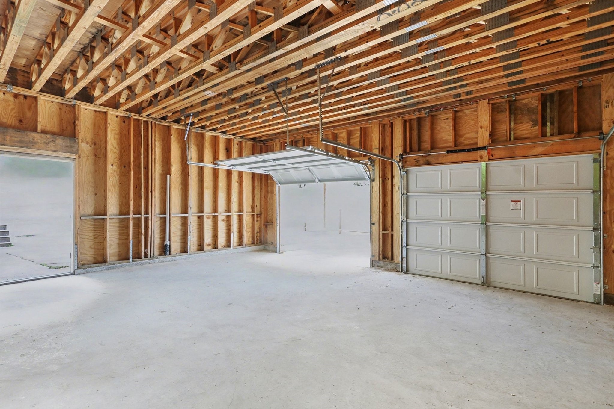 1901 Lexington Street Houston, TX 77098 - Photo 26 of 32 This unfinished garage space offers a blank canvas for customization, promising endless possibilities for storage or projects.
