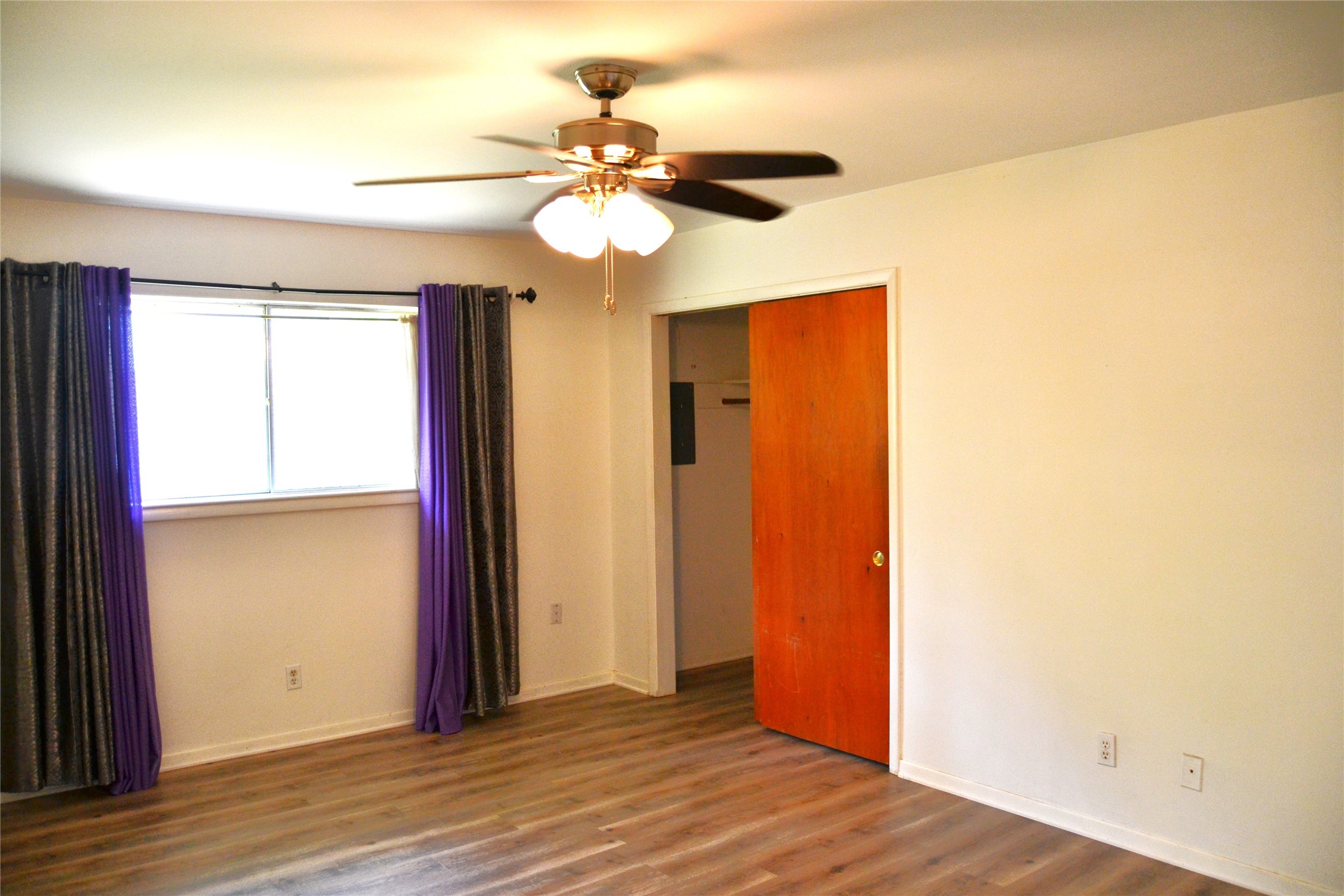 101 Summit Drive Conroe, TX 77303 - Photo 12 of 22 a view of an empty room with wooden floor and a window