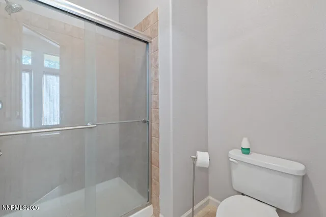 a white toilet sitting next to a bath tub