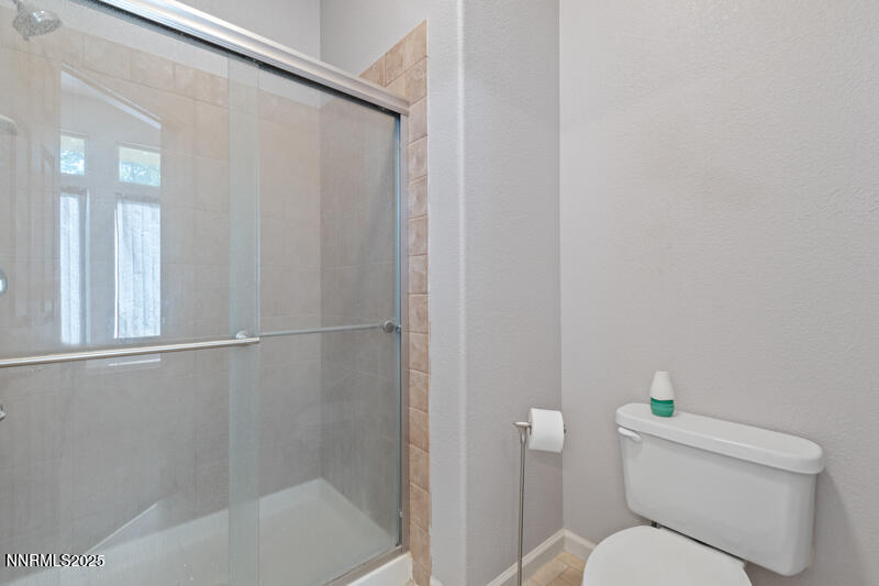 210 Nugget Avenue Dayton, NV 89403 - Photo 17 of 24 a white toilet sitting next to a bath tub