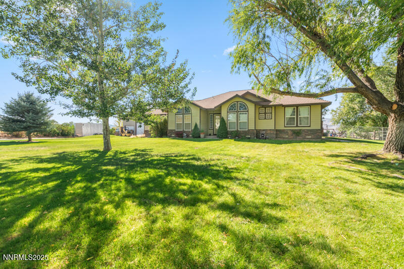 210 Nugget Avenue Dayton, NV 89403 - Photo 4 of 24 a yellow house in middle of the forest
