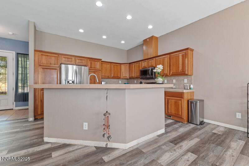 210 Nugget Avenue Dayton, NV 89403 - Photo 8 of 24 a kitchen with stainless steel appliances granite countertop a sink and stove top oven
