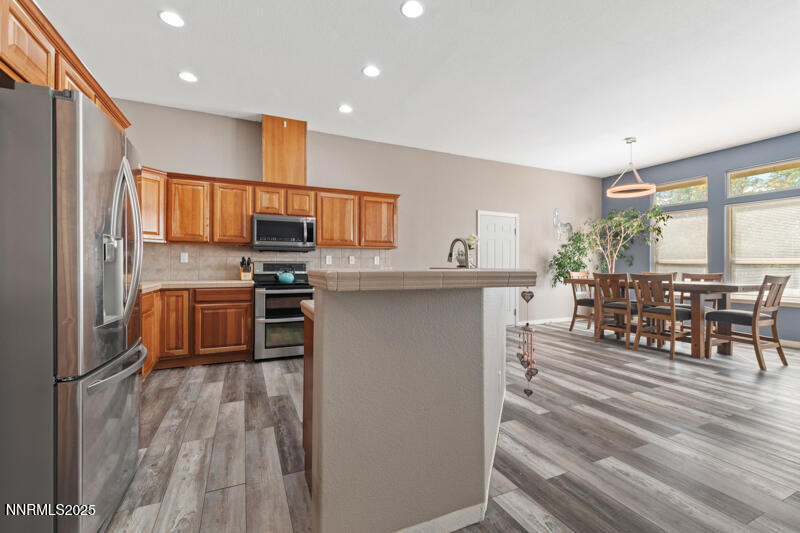 210 Nugget Avenue Dayton, NV 89403 - Photo 9 of 24 a kitchen with stainless steel appliances a refrigerator and a stove top oven
