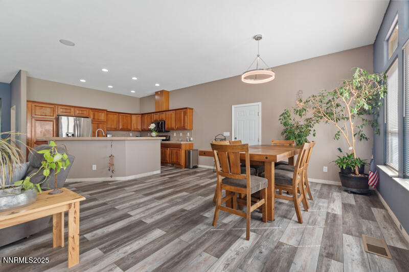 210 Nugget Avenue Dayton, NV 89403 - Photo 10 of 24 a view of a dining room with furniture and wooden floor