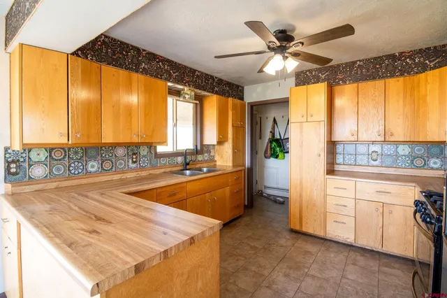 a large white kitchen with a large window