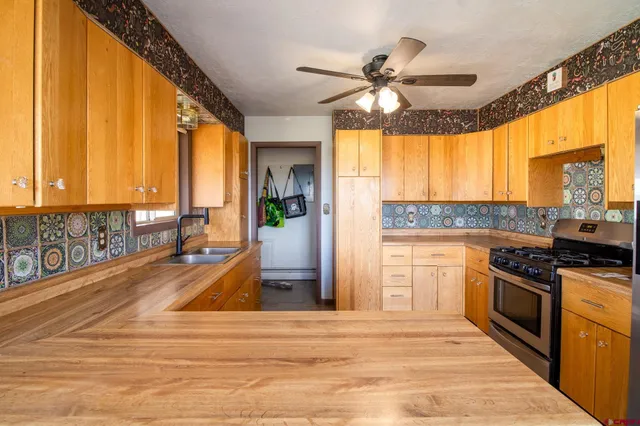 a kitchen with stainless steel appliances granite countertop a stove and a sink