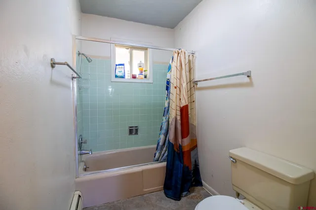 a bathroom with a toilet and a bathtub
