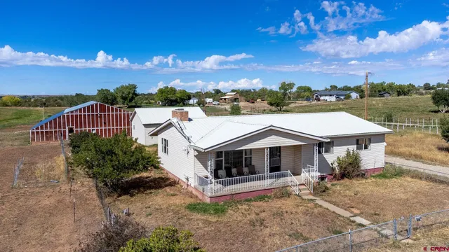 a aerial view of a house with a yard and balcony