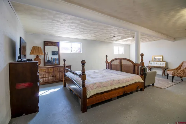 a bedroom with bed and window