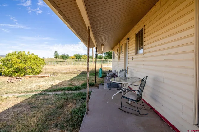 a view of a patio with table and chairs and potted plants