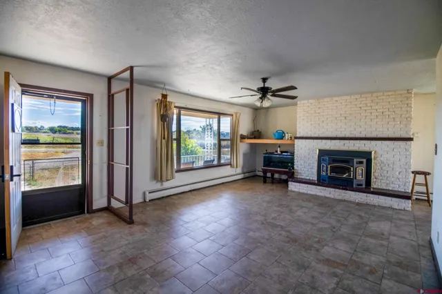 a view of a livingroom with an empty space and a fireplace