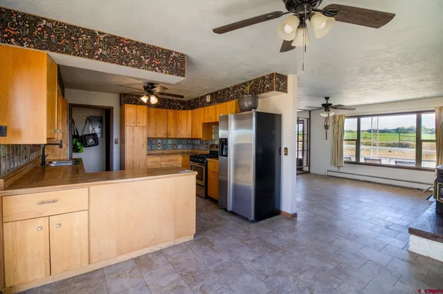 a kitchen with refrigerator and window