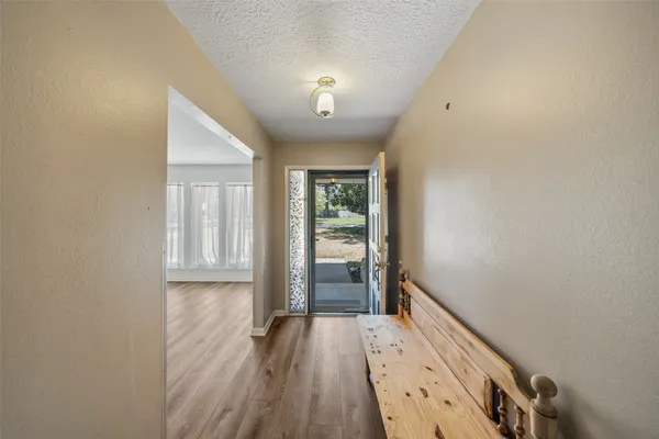 a view of an entryway with wooden floor