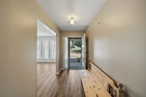 a view of an entryway with wooden floor