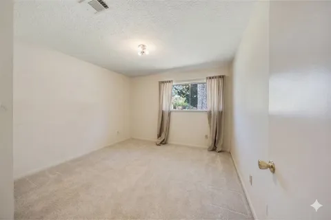 a view of an empty room and a window