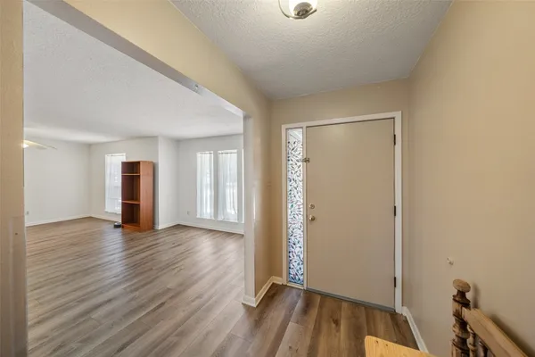 an empty room with wooden floor and closet