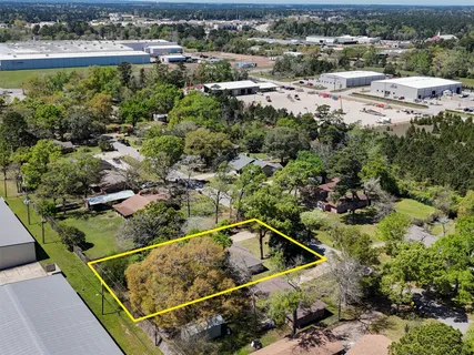 an aerial view of a residential houses with outdoor space and swimming pool