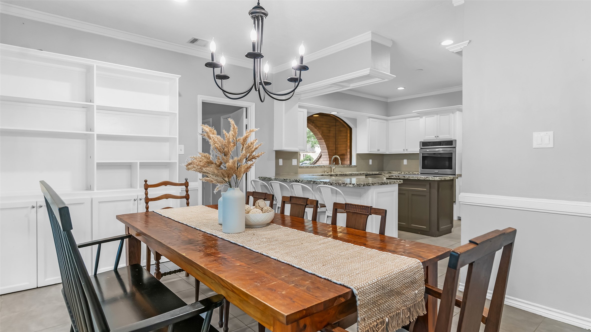 2607 Laurel Ridge Drive Houston, TX 77345 - Photo 17 of 47 a view of a dining room with furniture a chandelier and wooden floor