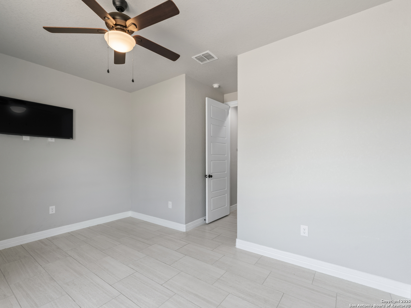 132 West Medium Meadow Drive Lytle, TX 78052 - Photo 16 of 46 an empty room with wooden floor and fan