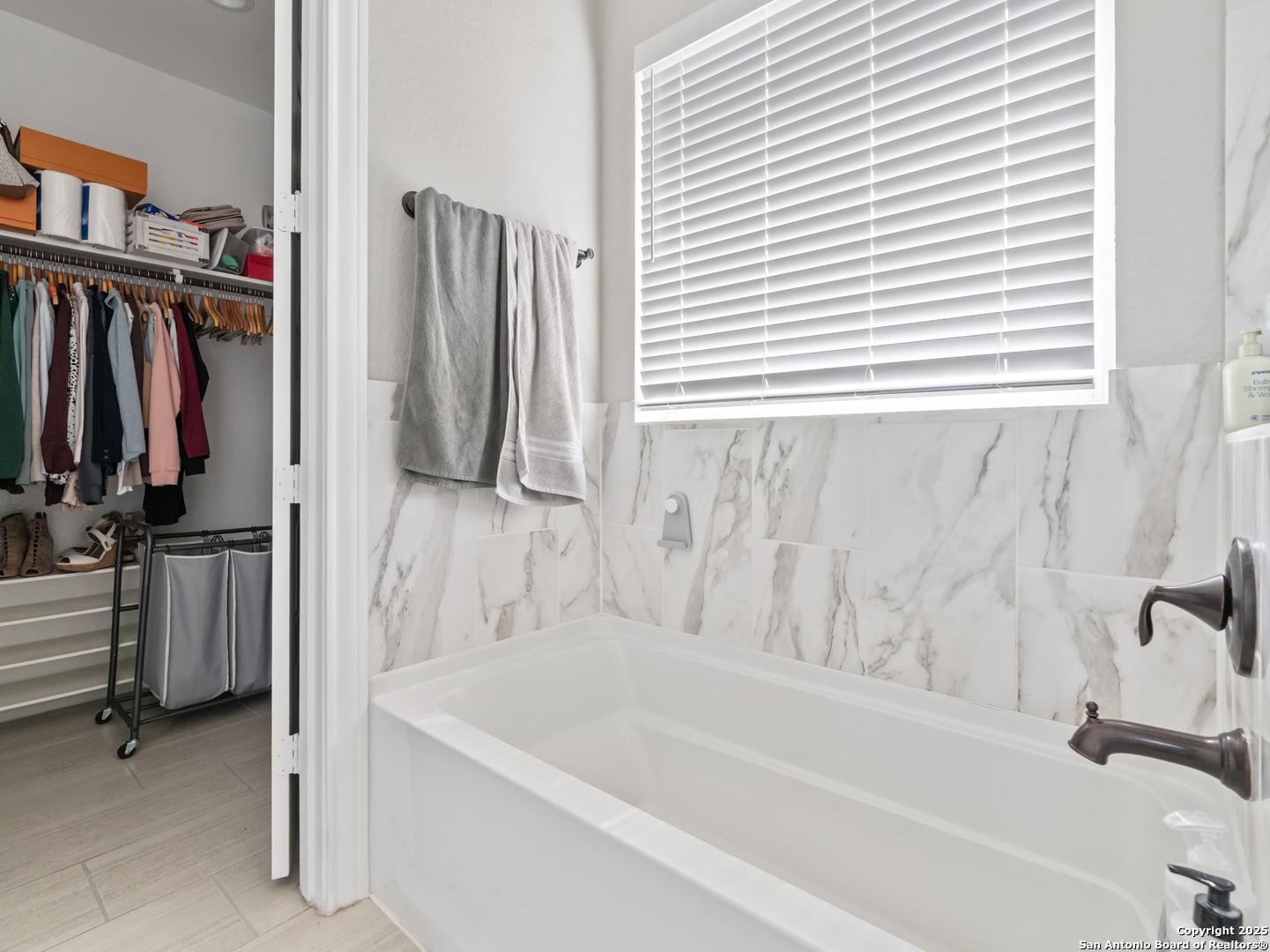 132 West Medium Meadow Drive Lytle, TX 78052 - Photo 17 of 46 a bathroom with a tub and a window