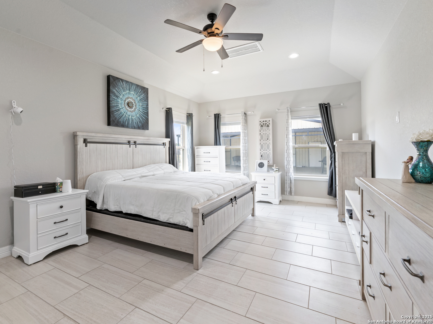 132 West Medium Meadow Drive Lytle, TX 78052 - Photo 29 of 46 a bedroom with a bed and a chandelier