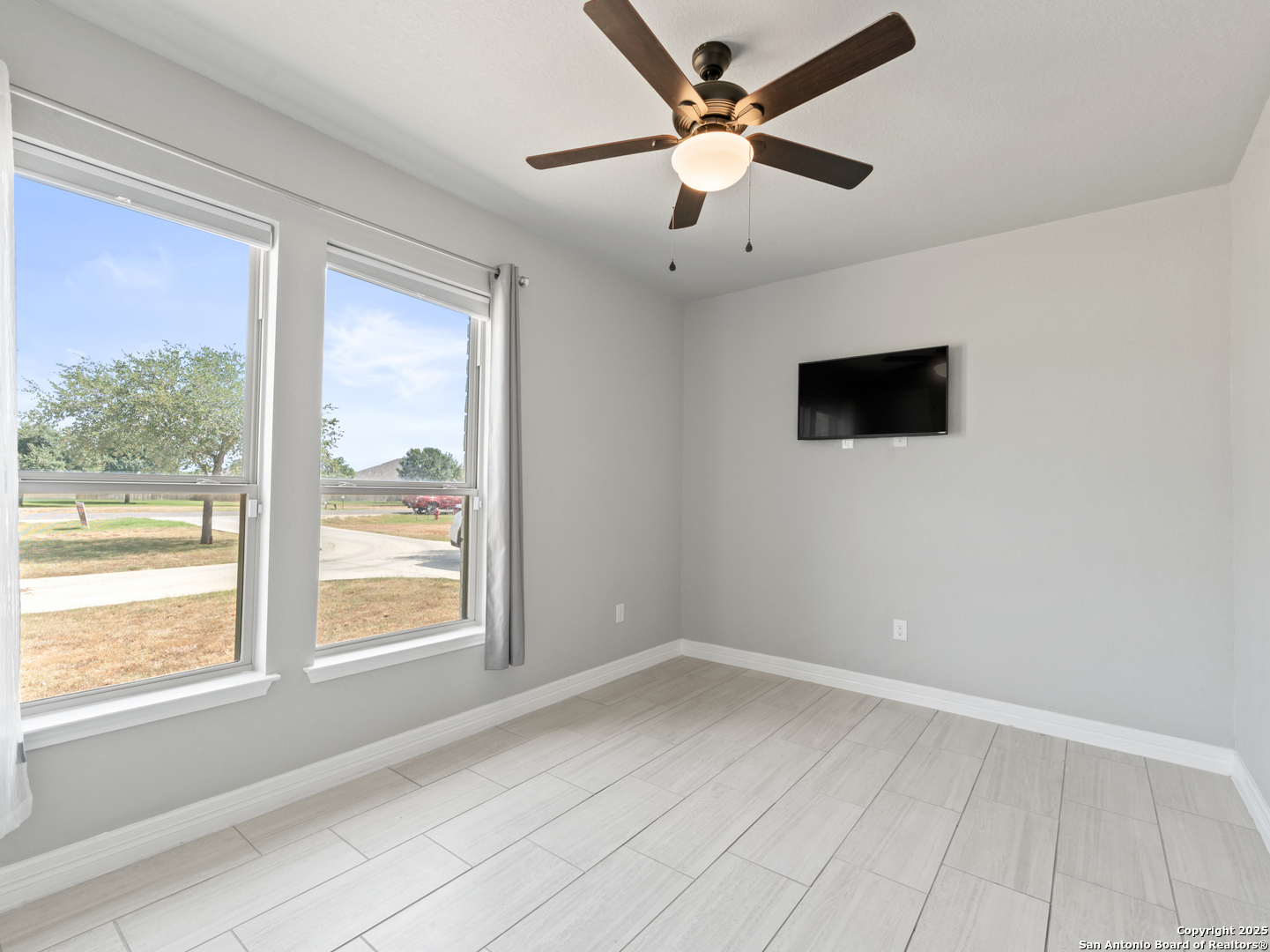132 West Medium Meadow Drive Lytle, TX 78052 - Photo 30 of 46 an empty room with a window and a fan