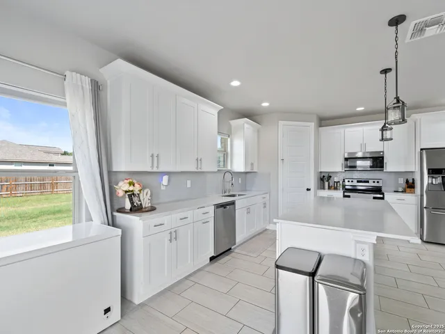 a kitchen with stainless steel appliances a refrigerator stove microwave and sink