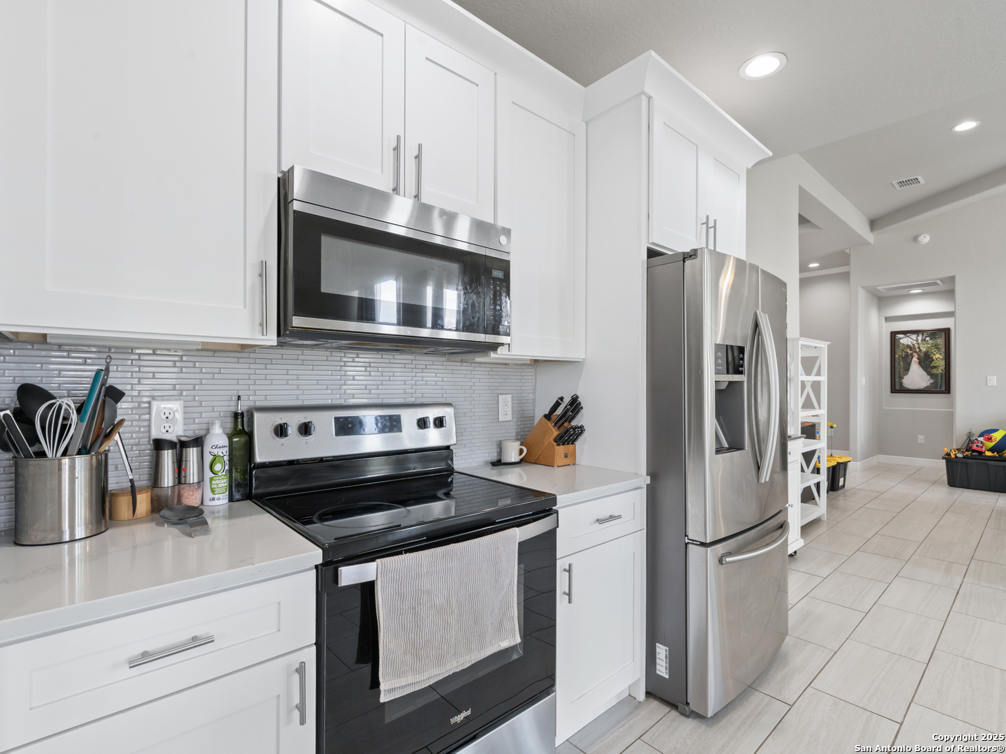 132 West Medium Meadow Drive Lytle, TX 78052 - Photo 35 of 46 a kitchen with stainless steel appliances a refrigerator stove microwave and sink