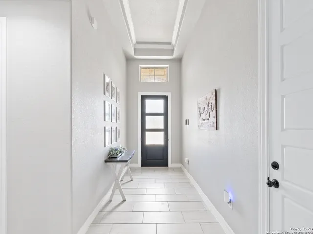 a view of a hallway with windows and closet
