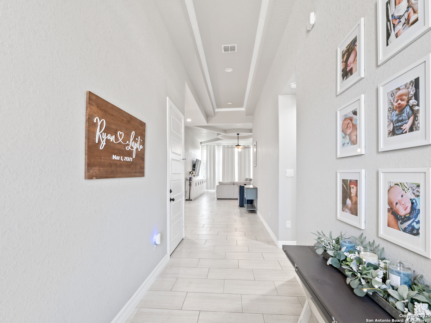 132 West Medium Meadow Drive Lytle, TX 78052 - Photo 6 of 46 a hallway with painting on the wall and a potted plant