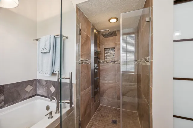 a bedroom with a large bed and a potted plant